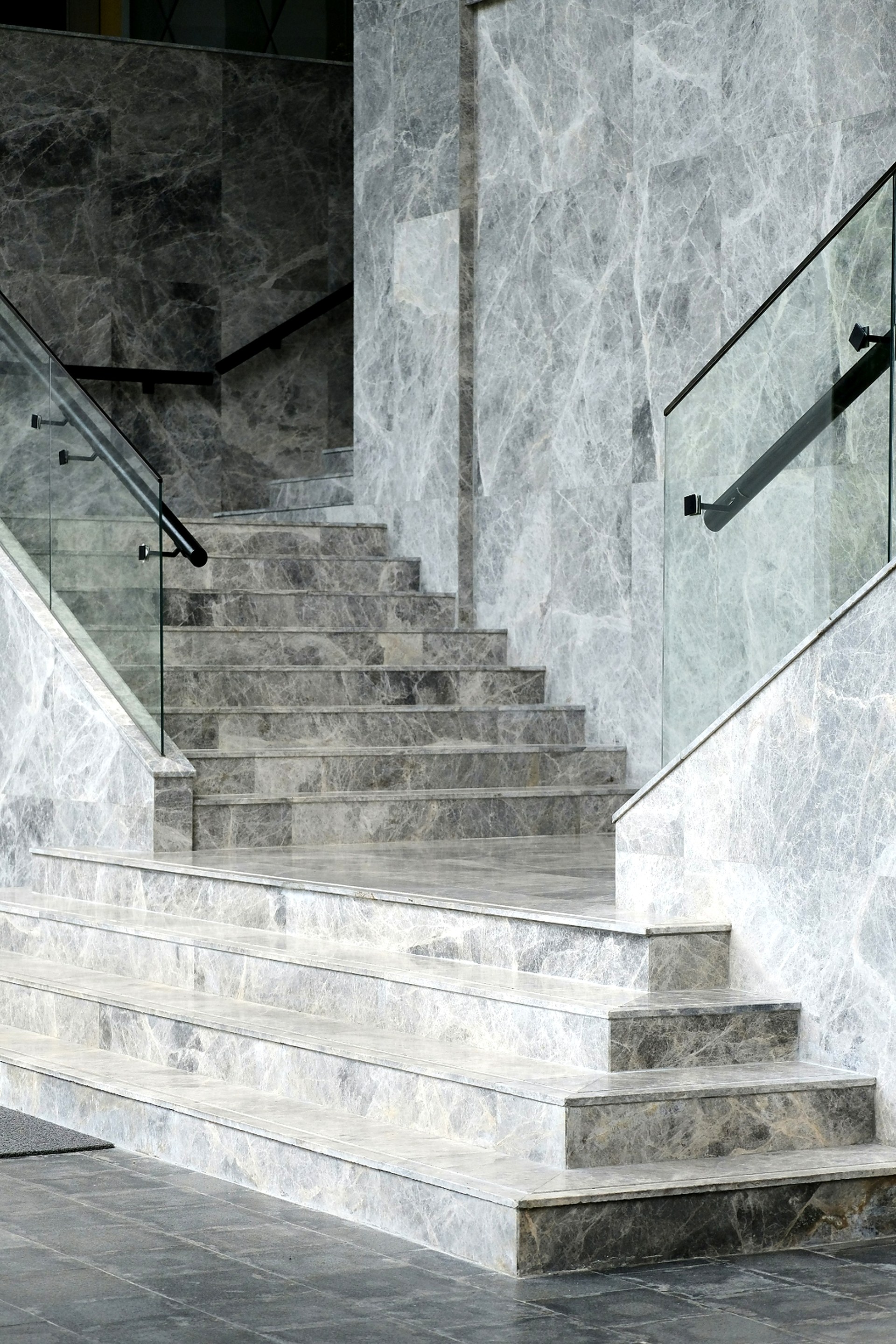 Marble staircase with glass railings